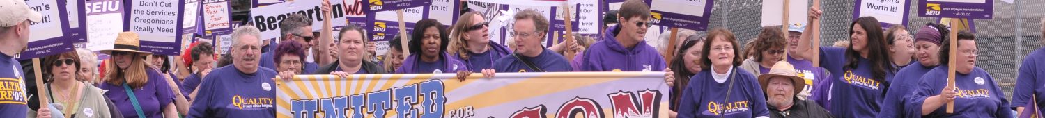 A large crowd of SEIU members, all wearing purple, take up all lanes on a road, marching with banners and signs. Some signs read "United for Oregon", "Share the Sacrifice" and "Don't cut services: Raise Corporate Minimum Tax".